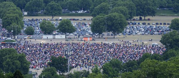 Participants take part in a rally against coronavirus restrictions, at the Cannstatter Wasen, in Stuttgart Participants take part in a rally against coronavirus restrictions, at the Cannstatter Wasen, in Stuttgart - Sputnik International