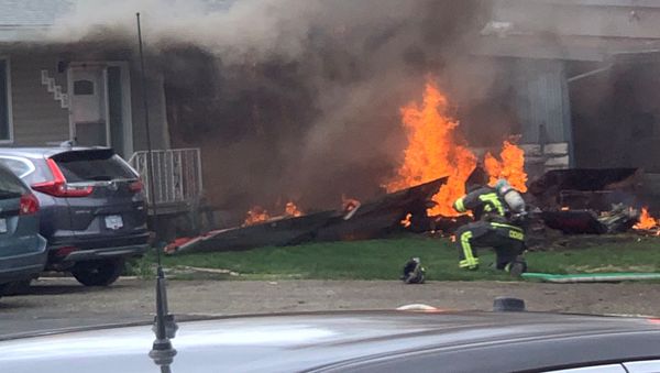 The crash site of a jet from the Canadian air force's Snowbirds aerobatics team is seen in a residential neighbourhood in Kamloops, British Columbia, Canada, May 17, 2020, in this image obtained from social media - Sputnik International