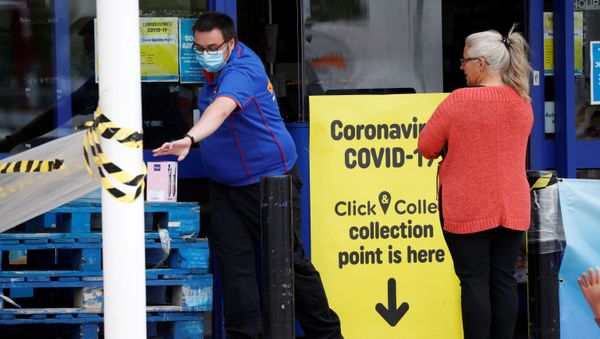 An employee wearing a protective face mask is seen with a customer at a Smyths in Wigan, following the outbreak of the coronavirus disease (COVID-19), Wigan, Britain, May 18, 2020.  - Sputnik International
