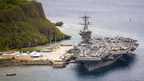 The aircraft carrier USS Theodore Roosevelt (CVN 71) is moored pier side at Naval Base Guam May 15, 2020. Theodore Roosevelt's COVID-negative crew returned from quarantine beginning on April 29 and is making preparations to return to sea to continue their scheduled deployment to the Indo-Pacific. - Sputnik International