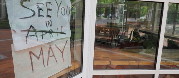 The sign on Sip Cafe reads See you in May, with April crossed out, amid the coronavirus disease (COVID-19) outbreak in Boston, Massachusetts, U.S., May 18, 2020.    - Sputnik International