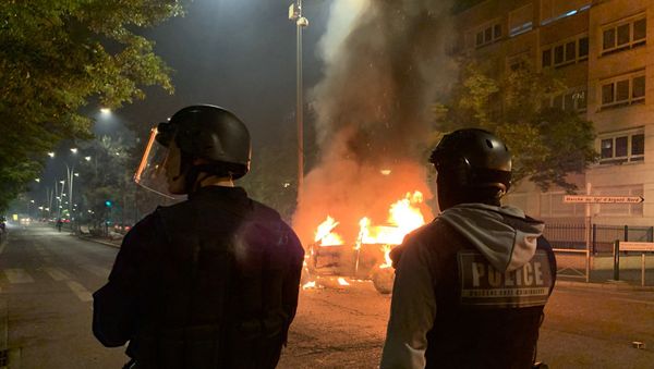 Riot police look on against the backdrop of a car that was set on fire on 18 May during protests against the death of an 18-year-old motorcyclist in Argenteuil, Paris. - Sputnik International