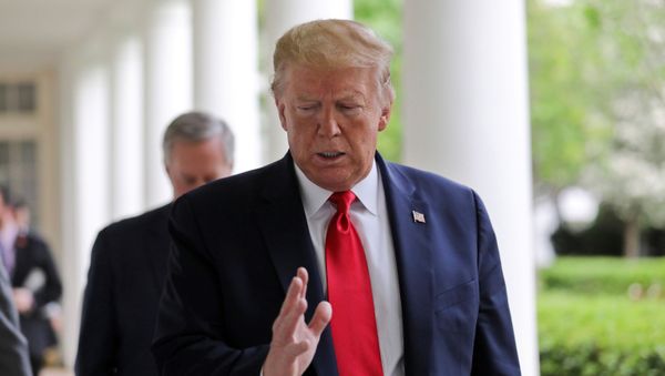 U.S. President Donald Trump talks with a Reuters reporter as they walk down the West Wing colonnade before an interview about China, the novel coronavirus (COVID-19) pandemic and other subjects in the Oval Office of the White House in Washington, U.S., April 29, 2020.  - Sputnik International