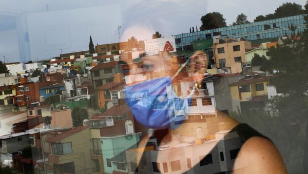 Monica Samudio, 46, whose husband Jorge Garcia, 51, died from the coronavirus disease (COVID-19), is reflected in the window as she looks out of her new apartment, in Mexico City, Mexico April 29, 2020 Monica Samudio, 46, whose husband Jorge Garcia, 51, died from the coronavirus disease (COVID-19), is reflected in the window as she looks out of her new apartment, in Mexico City, Mexico April 29, 2020 - Sputnik International
