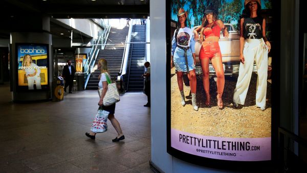 A shopper walks past an advertising billboards for Boohoo and for 'Pretty Little Things', a Boohoo brand, at Canary Wharf DLR station in central London, Britain, 17 September 2018 A shopper walks past an advertising billboards for Boohoo and for 'Pretty Little Things', a Boohoo brand, at Canary Wharf DLR station in central London, Britain, 17 September 2018 - Sputnik International