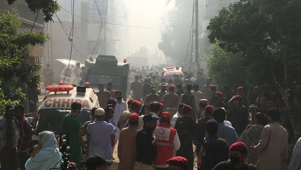Ambulances and fire brigade vehicles gather at the site of a passenger plane crash in a residential area near an airport in Karachi, Pakistan May 22, 2020 - Sputnik International