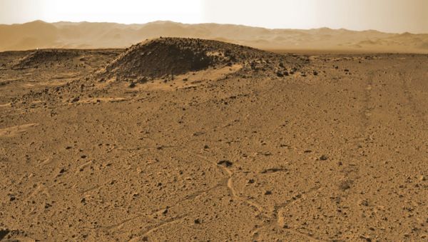 Curiosity manoeuvres into 'Kimberley' and scans scientifically intriguing Martian rock outcrops in search of its next drilling location exhibiting several shallow hills in the foreground and the dramatic Gale crater rim backdrop. Rover tracks at right in this coloured Navcam photomosaic assembled from raw images snapped on Sol 589, 3 April 2014.  - Sputnik International