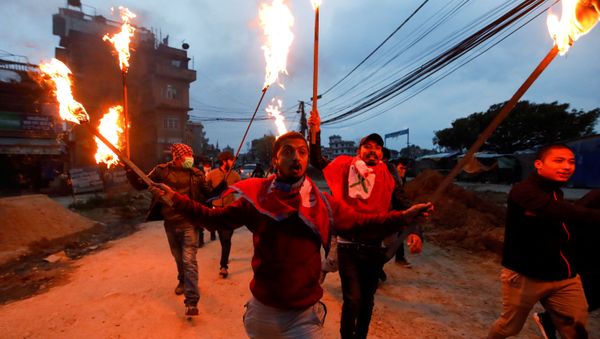 Students with torches protest against the alleged encroachment of Nepal border by India in far west of Nepal, during the 49th day of a lockdown imposed by the government amid concerns about the spread of the coronavirus disease (COVID-19), in Kathmandu, Nepal May 11, 2020 - Sputnik International