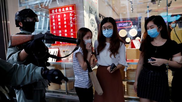 Riot police disperse anti-government protesters during a lunch time protest in Central, as a second reading of a controversial national anthem law takes place in Hong Kong, China May 27, 2020 Riot police disperse anti-government protesters during a lunch time protest in Central, as a second reading of a controversial national anthem law takes place in Hong Kong, China May 27, 2020 - Sputnik International