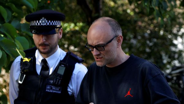 Dominic Cummings, special advisor for Britain's Prime Minister Boris Johnson, with a police officer as he leaves his home in London, following the outbreak of the coronavirus disease (COVID-19), London, Britain, May 29, 2020 - Sputnik International