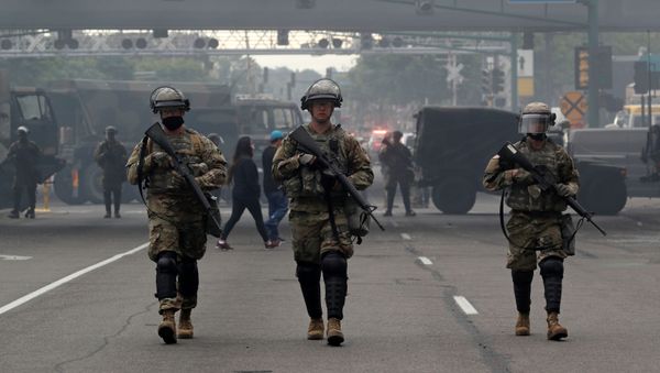 National Guard members walk at the area in the aftermath of a protest after a white police officer was caught on a bystander's video pressing his knee into the neck of African-American man George Floyd, who later died at a hospital, in Minneapolis, Minnesota, U.S., May 29, 2020 - Sputnik International