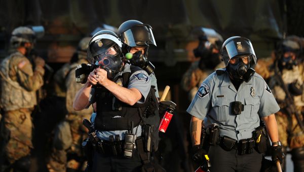A Minneapolis Police Department officer fires a less-lethal round during continued demonstrations against the death in Minneapolis police custody of African-American man George Floyd, in Minneapolis, Minnesota, U.S., May 29, 2020. Picture taken May 29, 2020 - Sputnik International