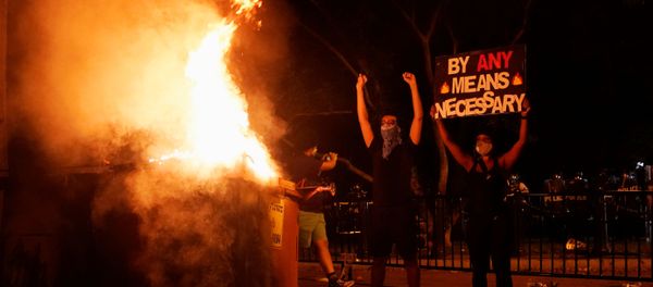 Demonstrators gesture and hold a sign next to a fire during a rally near the White House against the death in Minneapolis police custody of George Floyd in Washington, D.C. U.S. May 30, 2020. Demonstrators gesture and hold a sign next to a fire during a rally near the White House against the death in Minneapolis police custody of George Floyd in Washington, D.C. U.S. May 30, 2020. - Sputnik International