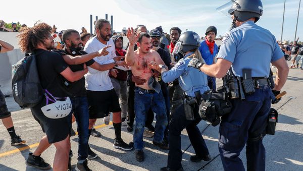 Protesters hand over to police the driver (C) of a tanker truck who drove into hundreds of protesters marching on 35W northbound highway during a protest against the death in Minneapolis police custody of George Floyd, in Minneapolis, Minnesota. - Sputnik International
