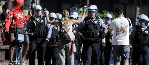 A person raises up their arms while blocking Chicago Police officers during a protest over the death of George Floyd in Chicago, Saturday, May 30, 2020 A person raises up their arms while blocking Chicago Police officers during a protest over the death of George Floyd in Chicago, Saturday, May 30, 2020 - Sputnik International