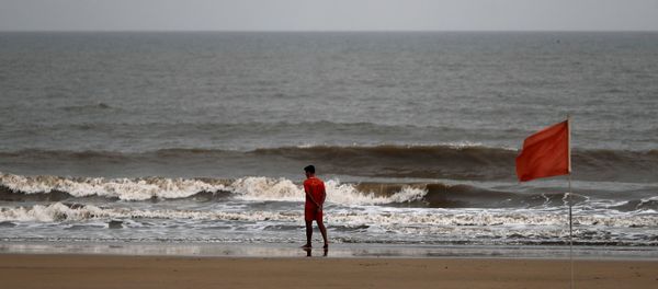 A lifeguard walks along the shore off the Arabian Sea before cyclone Nisarga makes its landfall, in Mumbai, India, June 2, 2020. REUTERS/Francis Mascarenhas A lifeguard walks along the shore off the Arabian Sea before cyclone Nisarga makes its landfall, in Mumbai, India, June 2, 2020. REUTERS/Francis Mascarenhas - Sputnik International