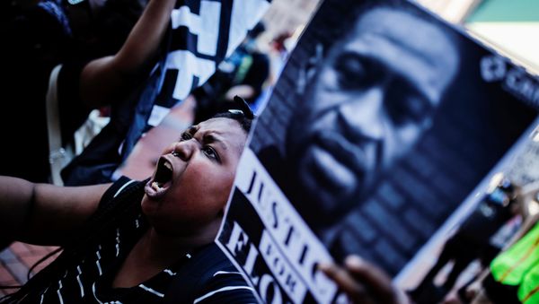 A protester reacts while gathering with others outside the city hall after a white police officer was caught on a bystander's video pressing his knee into the neck of African-American man George Floyd, who later died at a hospital, in Minneapolis, Minnesota, U.S., May 28, 2020. - Sputnik International