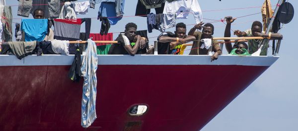 Migrants dry their clothes aboard a tourist boat some 20 kilometers from Malta, Tuesday, June 2, 2020. More than 400 migrants are living aboard pleasure cruise vessels, bobbing in the sea off Malta, many of them for weeks now. Rescued from human traffickers’ unseaworthy boats in several operations in the central Mediterranean since late April, the migrants, along with the Maltese government, are waiting for European Union countries to offer to take them. Migrants dry their clothes aboard a tourist boat some 20 kilometers from Malta, Tuesday, June 2, 2020. More than 400 migrants are living aboard pleasure cruise vessels, bobbing in the sea off Malta, many of them for weeks now. Rescued from human traffickers’ unseaworthy boats in several operations in the central Mediterranean since late April, the migrants, along with the Maltese government, are waiting for European Union countries to offer to take them. - Sputnik International