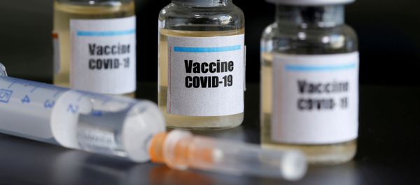 Small bottles labeled with a Vaccine COVID-19 sticker and a medical syringe are seen in this illustration taken taken April 10, 2020 Small bottles labeled with a Vaccine COVID-19 sticker and a medical syringe are seen in this illustration taken taken April 10, 2020 - Sputnik International