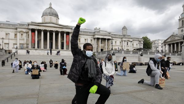 A protester makes a Black Lives Matter fist at a demonstration in Trafalgar Square in central London on June 5, 2020, to show solidarity with the Black Lives Matter movement in the wake of the killing of George Floyd, an unarmed black man who died after a police officer knelt on his neck in Minneapolis. A protester makes a Black Lives Matter fist at a demonstration in Trafalgar Square in central London on June 5, 2020, to show solidarity with the Black Lives Matter movement in the wake of the killing of George Floyd, an unarmed black man who died after a police officer knelt on his neck in Minneapolis. - Sputnik International