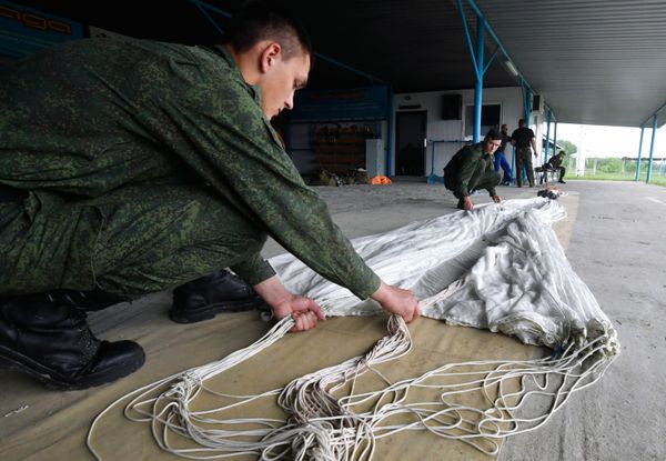 Recruits are folding a parachute after accomplishing their first jump at the Enem airfield in the Krasnodar Territory, Russia Recruits are folding a parachute after accomplishing their first jump at the Enem airfield in the Krasnodar Territory, Russia - Sputnik International