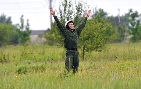 A recruit reacting to his first parachute jump at the Enem airfield of Russia's Volunteer Society for Cooperation with the Army, Aviation, and Navy (DOSAAF) in the Krasnodar Territory A recruit reacting to his first parachute jump at the Enem airfield of Russia's Volunteer Society for Cooperation with the Army, Aviation, and Navy (DOSAAF) in the Krasnodar Territory - Sputnik International