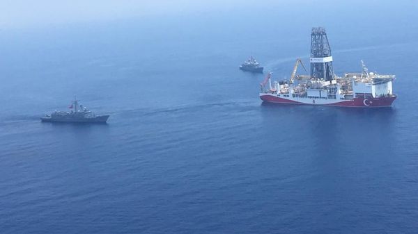 A handout photograph taken and released by the Turkish Defence Ministery on July 9,2019 shows a Turkish Navy warship patroling next to Turkey's drilling ship Fatih dispatched towards the eastern Mediterranean near Cyprus.  - Sputnik International