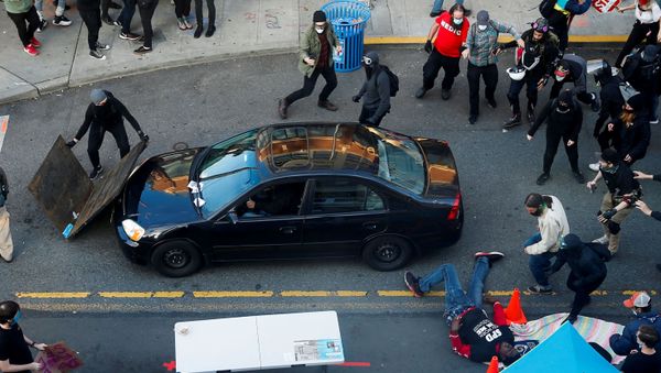 A man falls after being shot by a driver who tried to drive through a protest against racial inequality in the aftermath of the death in Minneapolis police custody of George Floyd, in Seattle, Washington, U.S. June 7, 2020 A man falls after being shot by a driver who tried to drive through a protest against racial inequality in the aftermath of the death in Minneapolis police custody of George Floyd, in Seattle, Washington, U.S. June 7, 2020 - Sputnik International