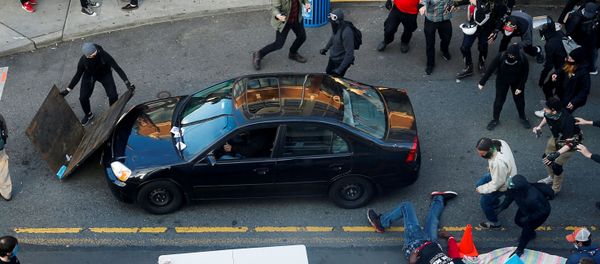 A man falls after being shot by a driver who tried to drive through a protest against racial inequality in the aftermath of the death in Minneapolis police custody of George Floyd, in Seattle, Washington, U.S. June 7, 2020 A man falls after being shot by a driver who tried to drive through a protest against racial inequality in the aftermath of the death in Minneapolis police custody of George Floyd, in Seattle, Washington, U.S. June 7, 2020 - Sputnik International