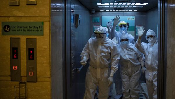 Medical workers wearing personal protective equipment (PPE) gesture as they arrive for their shift to work at the Intensive Care Unit (ICU) treating patients suffering from the coronavirus disease (COVID-19), at Max Smart Super Speciality Hospital in New Delhi, India, May 28, 2020 - Sputnik International