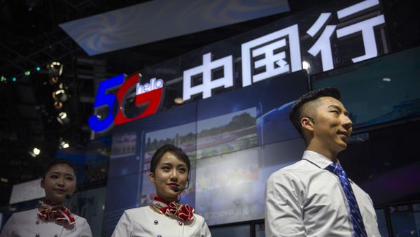 Staff members stand at a display for 5G services from Chinese technology firm China Telecom at the PT Expo in Beijing, Thursday, Oct. 31, 2019. - Sputnik International