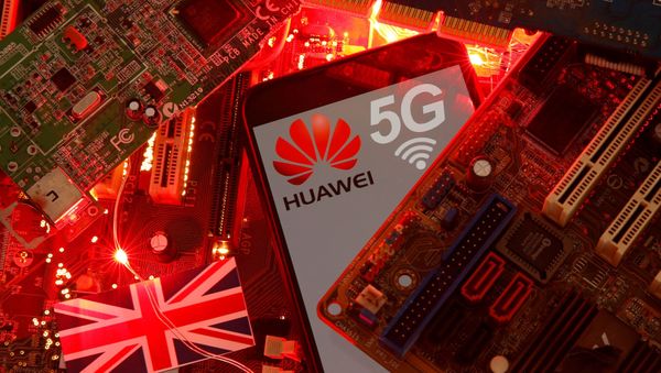 FILE PHOTO: The British flag and a smartphone with a Huawei and 5G network logo are seen on a PC motherboard in this illustration picture taken January 29, 2020. REUTERS/Dado Ruvic/File Photo - Sputnik International