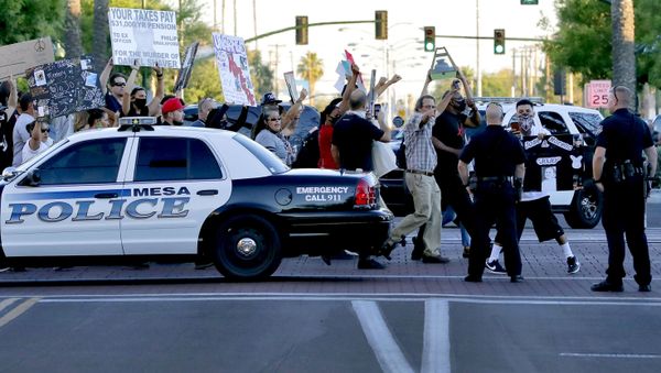 Protesters demanding police reform walk past Mesa police officers blocking a street, Tuesday, June 9, 2020, in Mesa, Ariz. The protest is a result of the death of George Floyd, a black man who died after being restrained by Minneapolis police officers on May 25 - Sputnik International