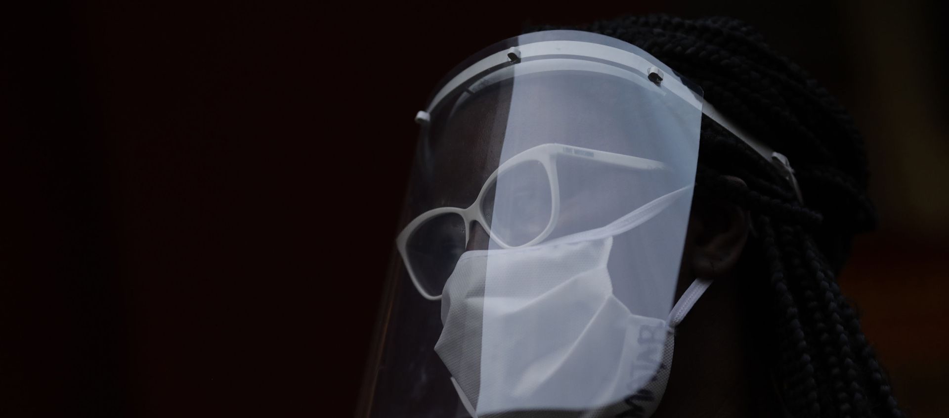 A woman wearing a face mask and shield to protect herself from the spread of the new coronavirus, takes part in a protest against racism and police violence during a Black Lives Matter demonstration amid in Duque de Caxias, Brazil, Wednesday, June 10, 2020. - Sputnik International, 1920