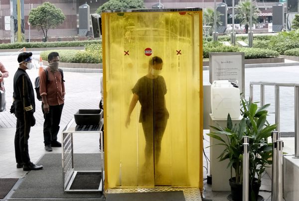 A woman reacts as she is sprayed with disinfectant inside a chamber as a precaution against the new coronavirus before entering a shopping mall in Jakarta, Indonesia, Tuesday, June 9, 2020. As Indonesia's overall virus caseload continues to rise, the capital city has moved to restore normalcy by lifting some restrictions this week, saying that the spread of the virus in the city of 11 million has slowed after peaking in mid-April. A woman reacts as she is sprayed with disinfectant inside a chamber as a precaution against the new coronavirus before entering a shopping mall in Jakarta, Indonesia, Tuesday, June 9, 2020. As Indonesia's overall virus caseload continues to rise, the capital city has moved to restore normalcy by lifting some restrictions this week, saying that the spread of the virus in the city of 11 million has slowed after peaking in mid-April. - Sputnik International