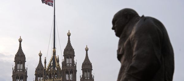 A statue of former British Prime Minister Winston Churchill stands near the Victoria Tower of the Houses of Parliament, as a British Union flag flies from a pole atop the tower, in London on December 8, 2016. A statue of former British Prime Minister Winston Churchill stands near the Victoria Tower of the Houses of Parliament, as a British Union flag flies from a pole atop the tower, in London on December 8, 2016. - Sputnik International