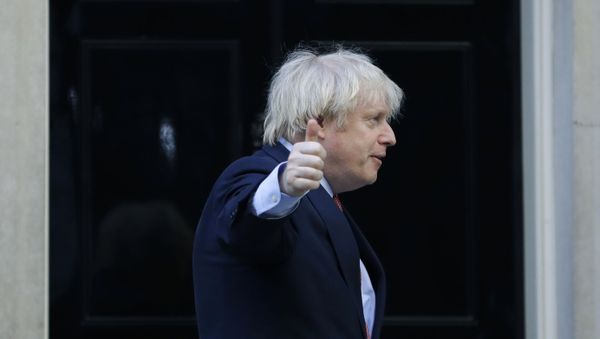 Britain's Prime Minister Boris Johnson gestures after applauding on the doorstep of 10 Downing Street, during the weekly Clap for our Carers, in London, Thursday, May 28, 2020 - Sputnik International