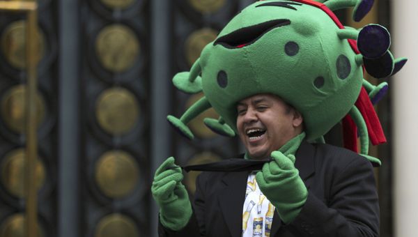 A street artist costumed as the new coronavirus laughs during a protest demanding the resumption of economic activities after not being able to earn a living since March because of the restrictions to curb the spread of COVID-19 in Mexico City, Thursday, June 11, 2020.  - Sputnik International