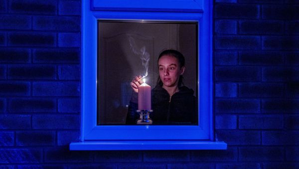 Woman lights a candle in the window of a home in Liverpool, England, after the Queen stressed the importance of maintaining the coronavirus lockdown during the Easter Bank Holiday weekend as she delivered what is believed to be her first Easter address, Saturday, April 11, 2020 Woman lights a candle in the window of a home in Liverpool, England, after the Queen stressed the importance of maintaining the coronavirus lockdown during the Easter Bank Holiday weekend as she delivered what is believed to be her first Easter address, Saturday, April 11, 2020 - Sputnik International