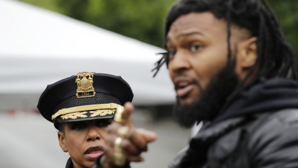 Seattle Police Chief Carmen Best, left, listens to activist Raz Simone as they talk near a plywood-covered and closed Seattle police precinct Tuesday, June 9, 2020, in Seattle, following protests over the death of George Floyd - Sputnik International