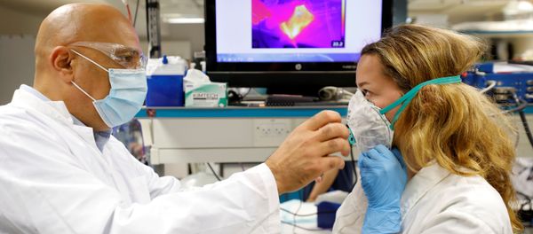 Israeli Professor Yair Ein-Eli, who led the research team which say they have invented a reusable face mask that can disinfect itself and kill the coronavirus disease (COVID-19), takes part in a demonstration for Reuters at a laboratory in Haifa, northern Israel June 10, 2020 - Sputnik International