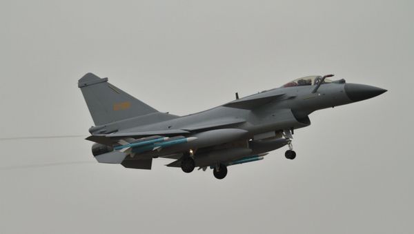 A Chengdu J-10 fighter of the Chinese People's Liberation Army Air Force (PLAAF) carrying PL-10 and PL-12 air-to-air missiles landing at Zhuhai Jinwan airport ahead of Airshow China 2018 - Sputnik International