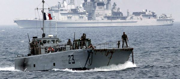Backdropped by French Navy ship Jean Bart, a French landing vessel carrying a bulldozer and military jeeps approaches the port of the southern border town of Naqoura, Lebanon, next to the headquarters of United Nations Interim Force In Lebanon, or UNIFIL, Saturday Aug. 19, 2006 - Sputnik International