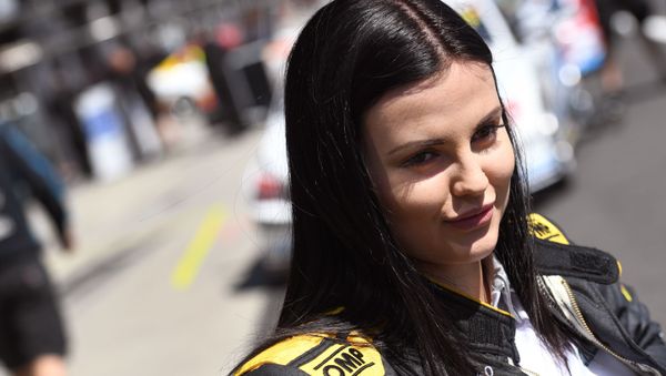 A photo taken on October 5, 2016 shows Australian racing driver Renee Gracie smiling during media interviews as she and co-driver Swiss driving ace Simona de Silvestro prepare for the Bathurst 1000 race on the Mount Panorama circuit at Bathurst on October 9 - Sputnik International