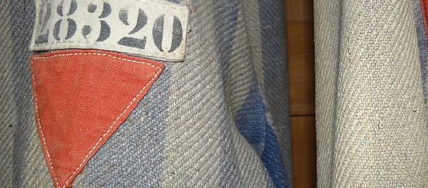Prisoners' Uniforms with Red Triangles of Political Prisoners. Museum Exhibit, Dachau Concentration Camp Site - Sputnik International