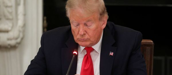 U.S. President Donald Trump uses a mobile phone during a roundtable discussion on the reopening of small businesses in the State Dining Room at the White House in Washington, U.S., June 18, 2020 - Sputnik International