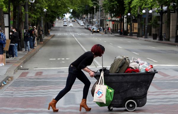 A woman pushes a cart during a protest against racial inequality and calling for defunding the Seattle police, in Seattle’s downtown, Washington, US. 14 June 2020. - Sputnik International