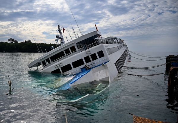 A ferry lists on its side at the Padangbai ferry port in Karangasem on Bali on 13 June 2020, after it took on water on 12 June while attempting to dock. Over 60 passengers and crew were rescued from the ferry, which was also transporting road vehicles, including several trucks. No casualties were reported. - Sputnik International