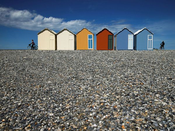 Cyclists are seen near beach huts on a pebble beach after France reopened its beaches to the public as it softens its strict lockdown rules amid the outbreak of the coronavirus disease in Cayeux-sur-Mer, France, 13 June 2020. - Sputnik International