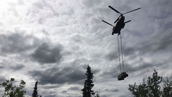 An Alaska Army National Guard CH-47 Chinook helicopter carries the bus made famous by the Into the Wild book and movie during its relocation near Stampede Trail west of Healy, Alaska, U.S. June 18, 2020. Alaska Department of Natural Resources/Handout via REUTERS.  THIS IMAGE HAS BEEN SUPPLIED BY A THIRD PARTY. - Sputnik International